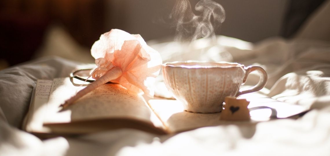 tea with book in bed