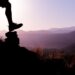 A man in top of a mountain enjoying the process