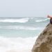 Girl practicing mindfulness by meditating in a beach